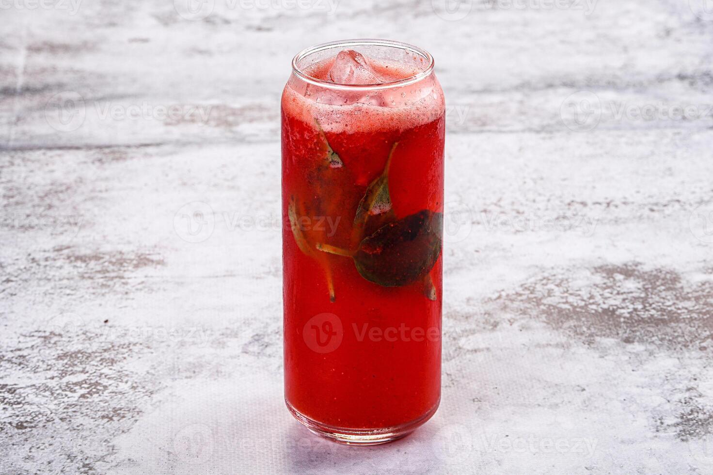 A red drink with a leaf on top photo