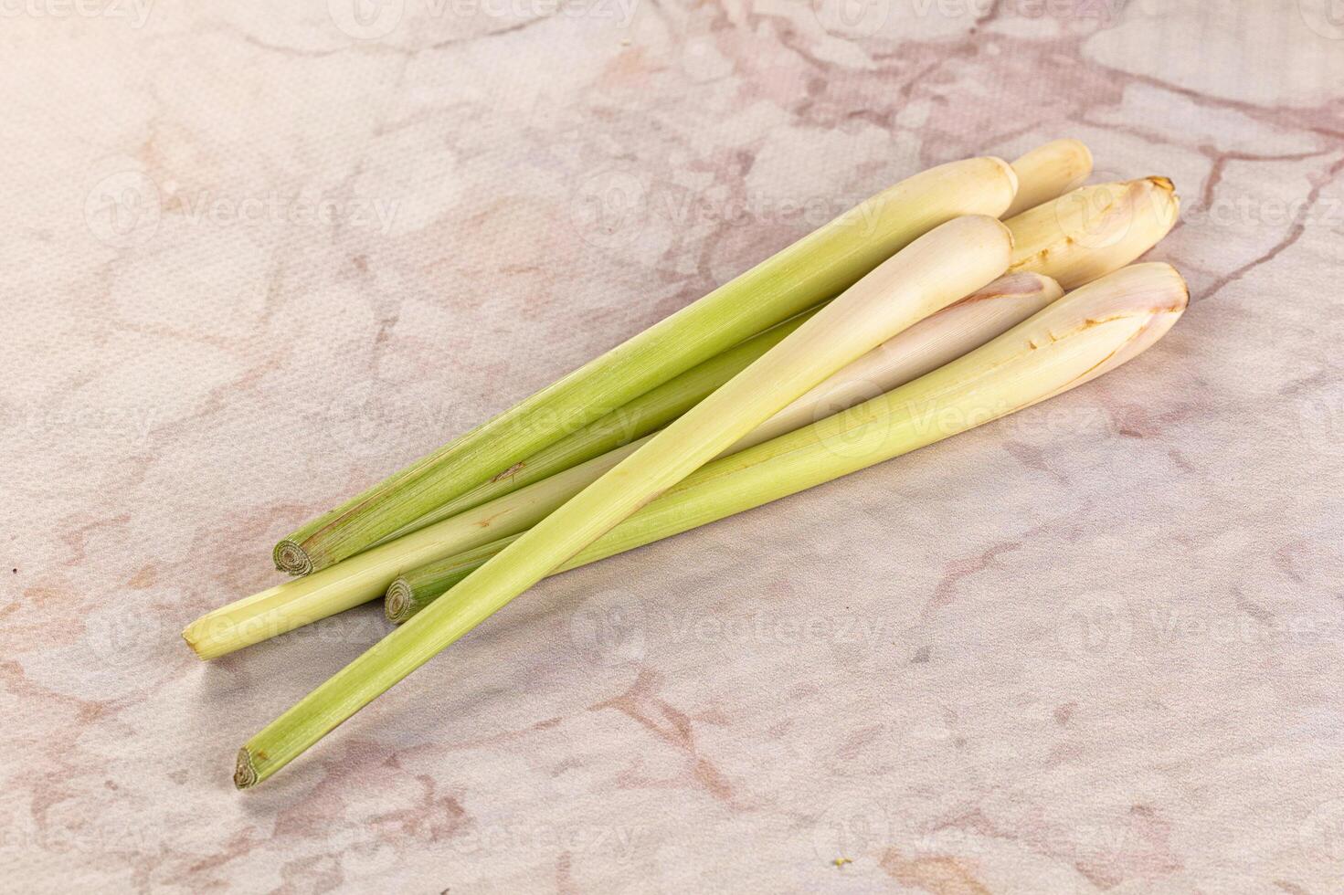 Three green leeks on a marble surface photo