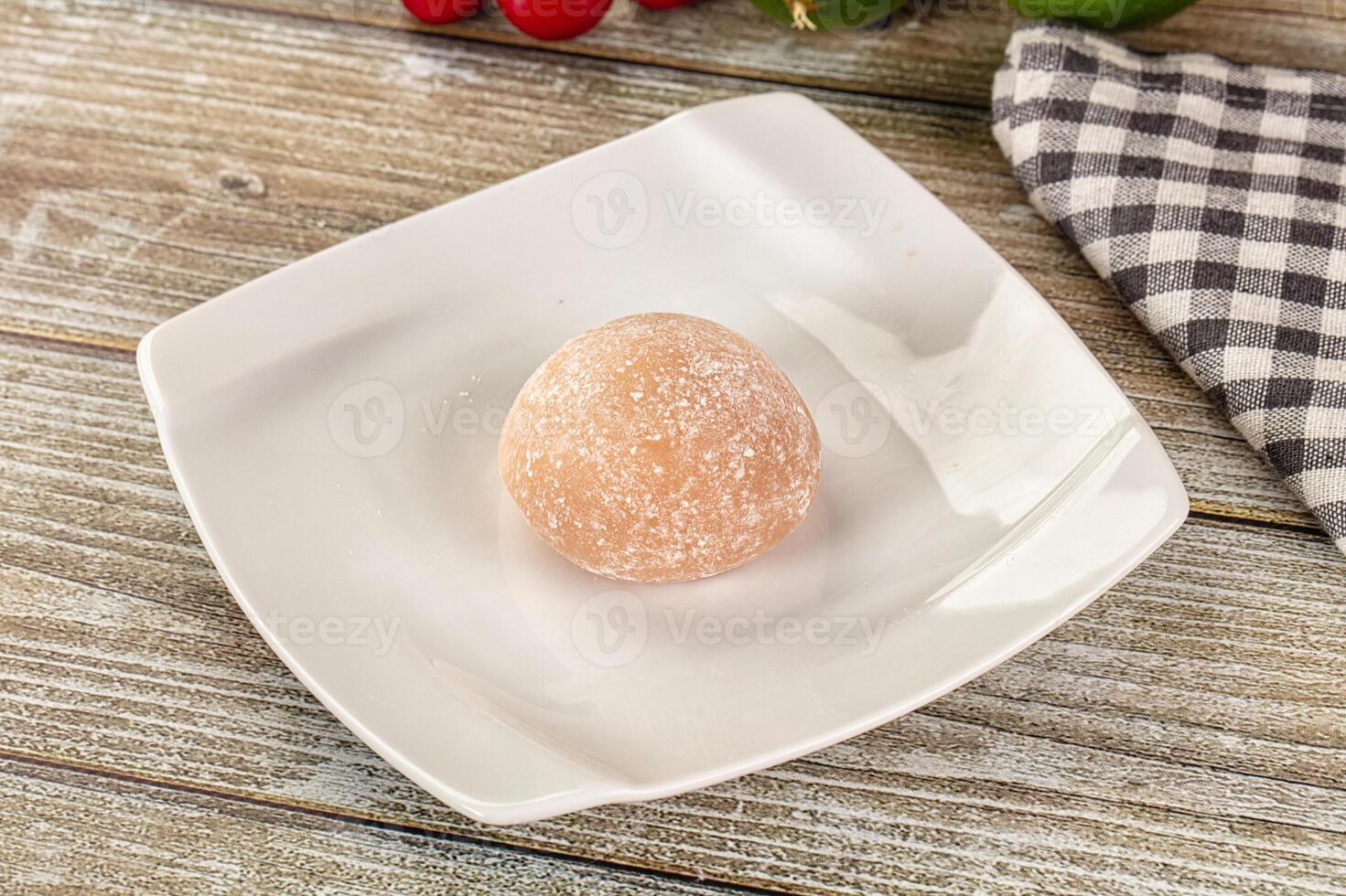 A white plate with a piece of fruit on it photo