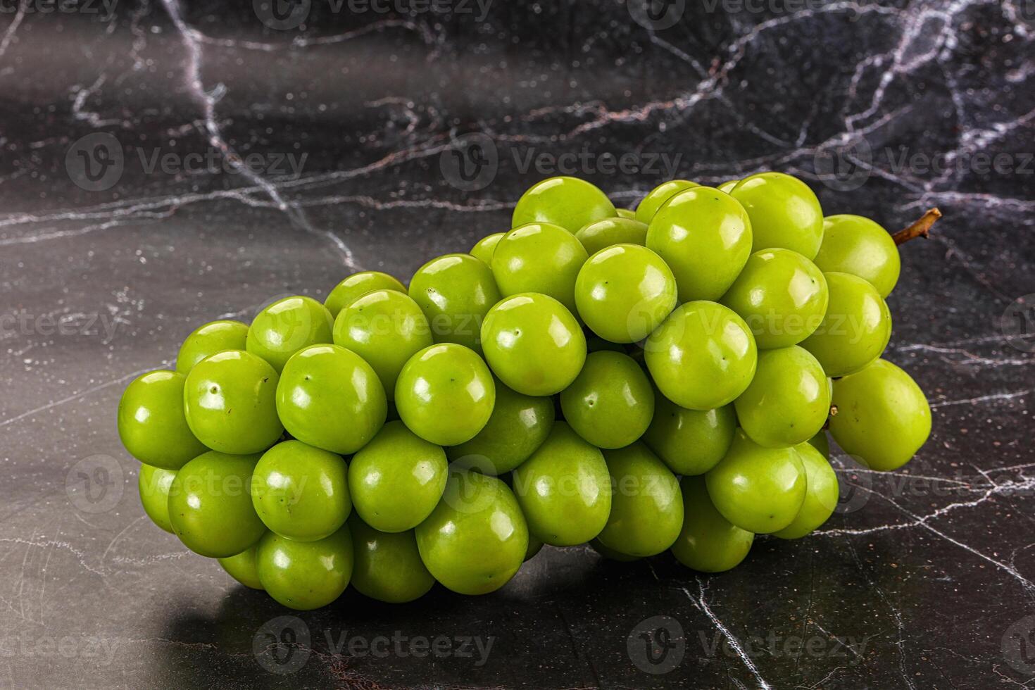 A bunch of green grapes on a marble table photo