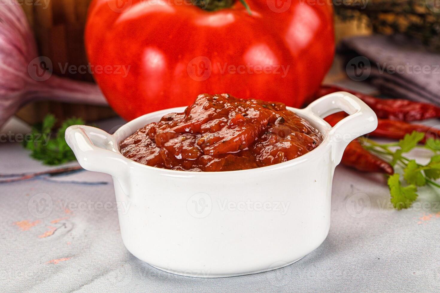 A white bowl with a tomato sauce in it photo