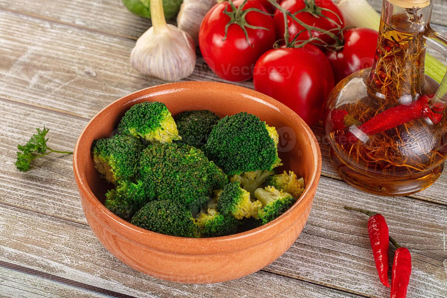 A bowl of broccoli with tomatoes, garlic, and other ingredients photo