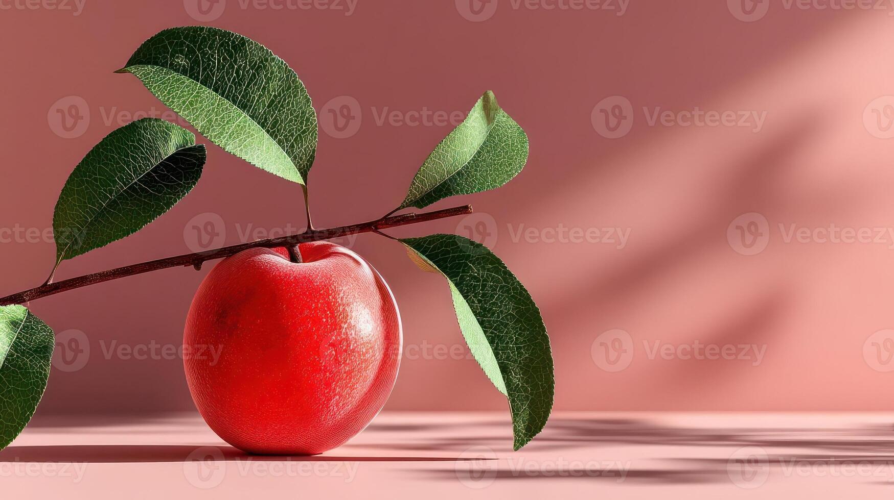 A vibrant red apple with a branch and leaves. photo