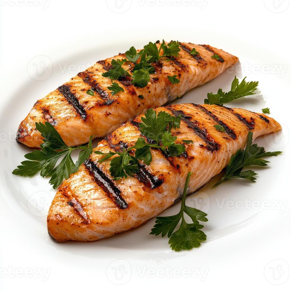Two grilled salmon fillets on a white plate photo