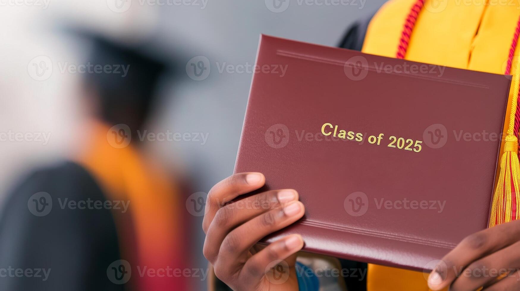 Hands showcase diploma for Class of 2025 against a soft-focused background, highlighting graduation pride photo