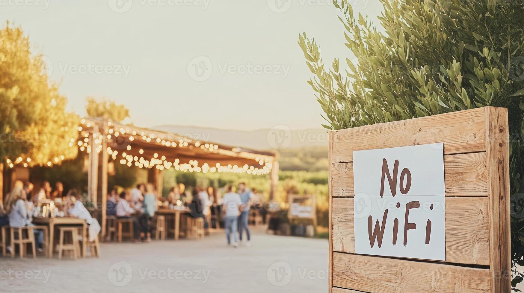 People gather around a large wooden table in a sunny morning setting, embracing conversation in a tech-free atmosphere photo