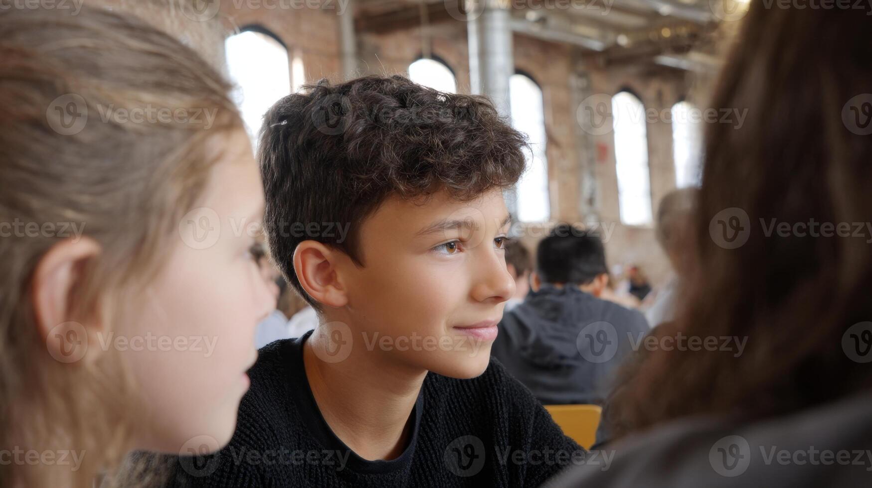 Young individuals actively participate in a modern art workshop within a restored warehouse gallery photo