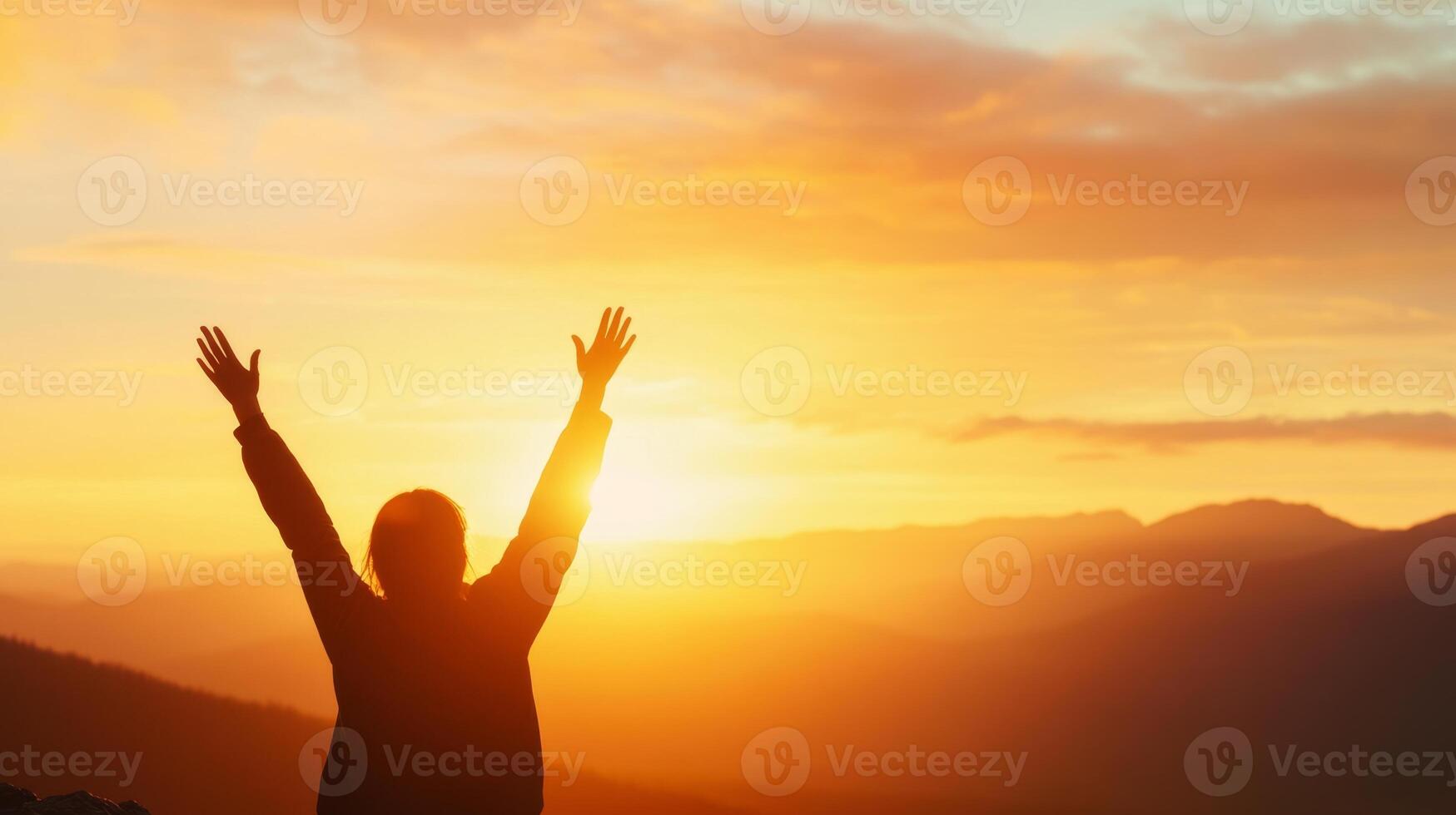 Silhouette of an individual embracing nature's beauty at sunset in the mountains, symbolizing freedom, Earth Day concept photo