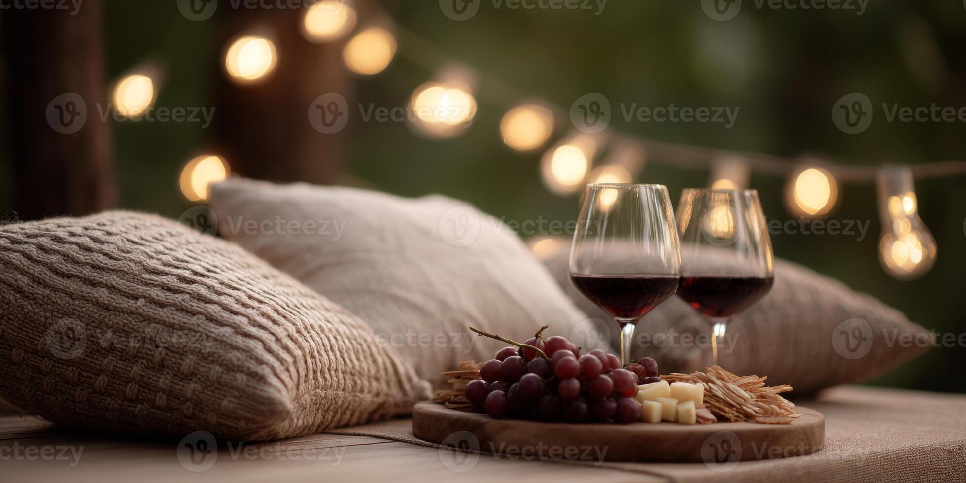 Enjoy a stylish picnic featuring artisan food, wine glasses, and warm lighting for a cozy atmosphere photo