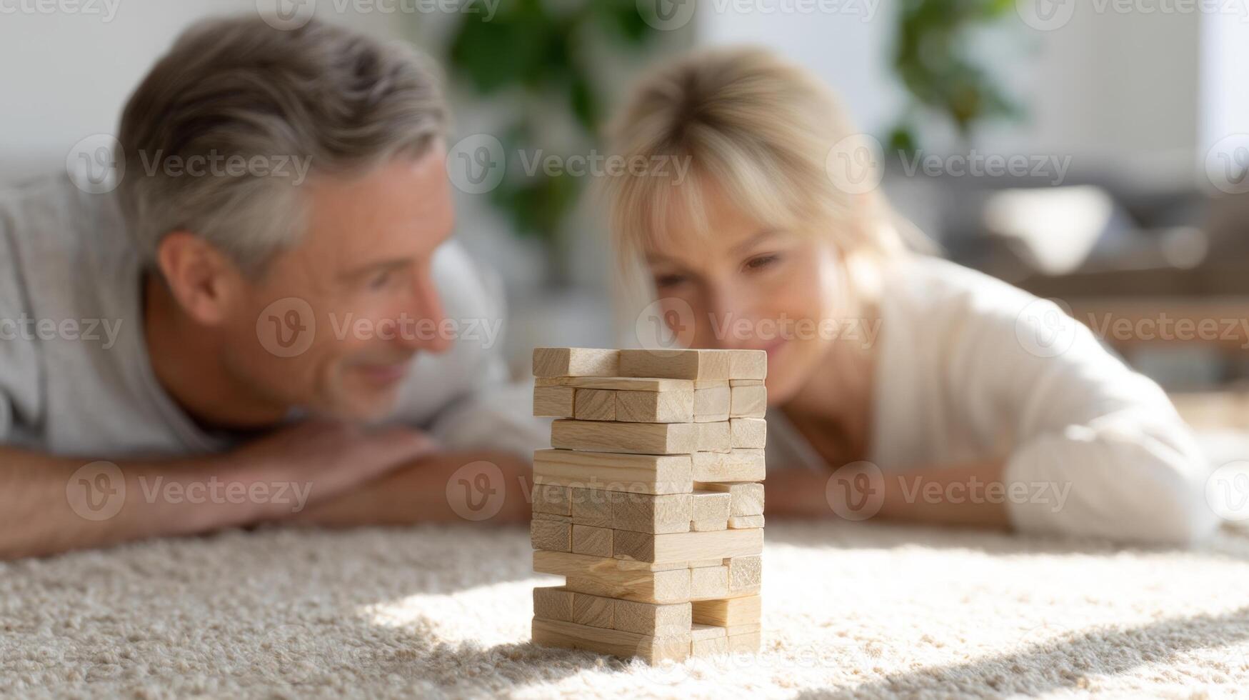 A couple plays Jenga on a cozy rug in a bright living room, filled with suspense and joy, kidults concept, kidults concept photo