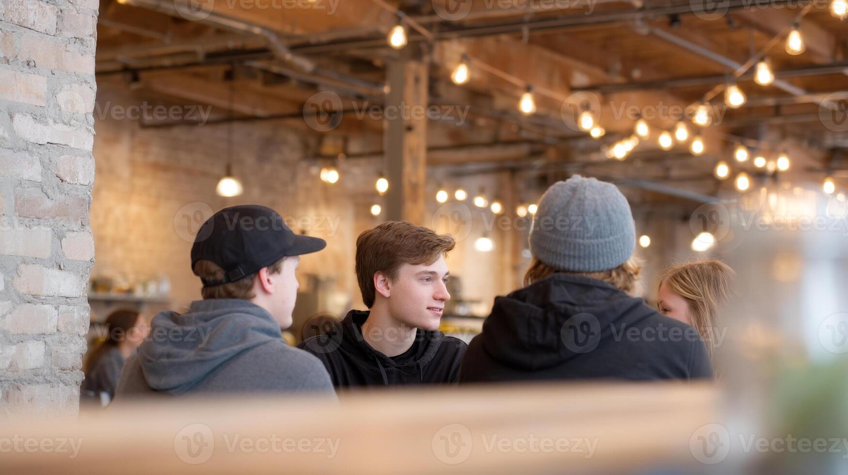 Friends gather in a cozy coffee shop with exposed brick and soft lighting, sharing laughs and stories photo