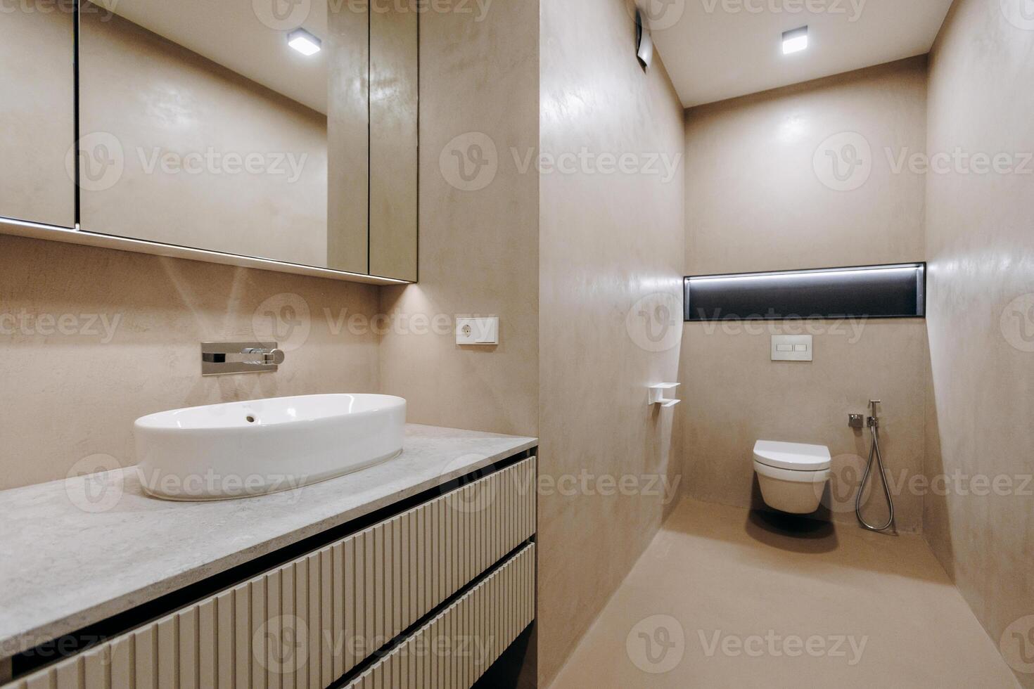A bathroom that includes a sink, toilet, and mirror for use photo