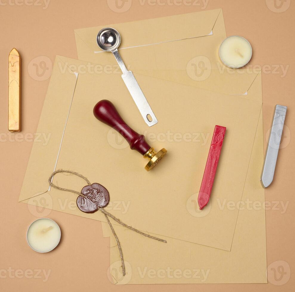 wax seal kit including wax sticks, spoon, candles, stamp and sealed scroll placed on a neutral background photo