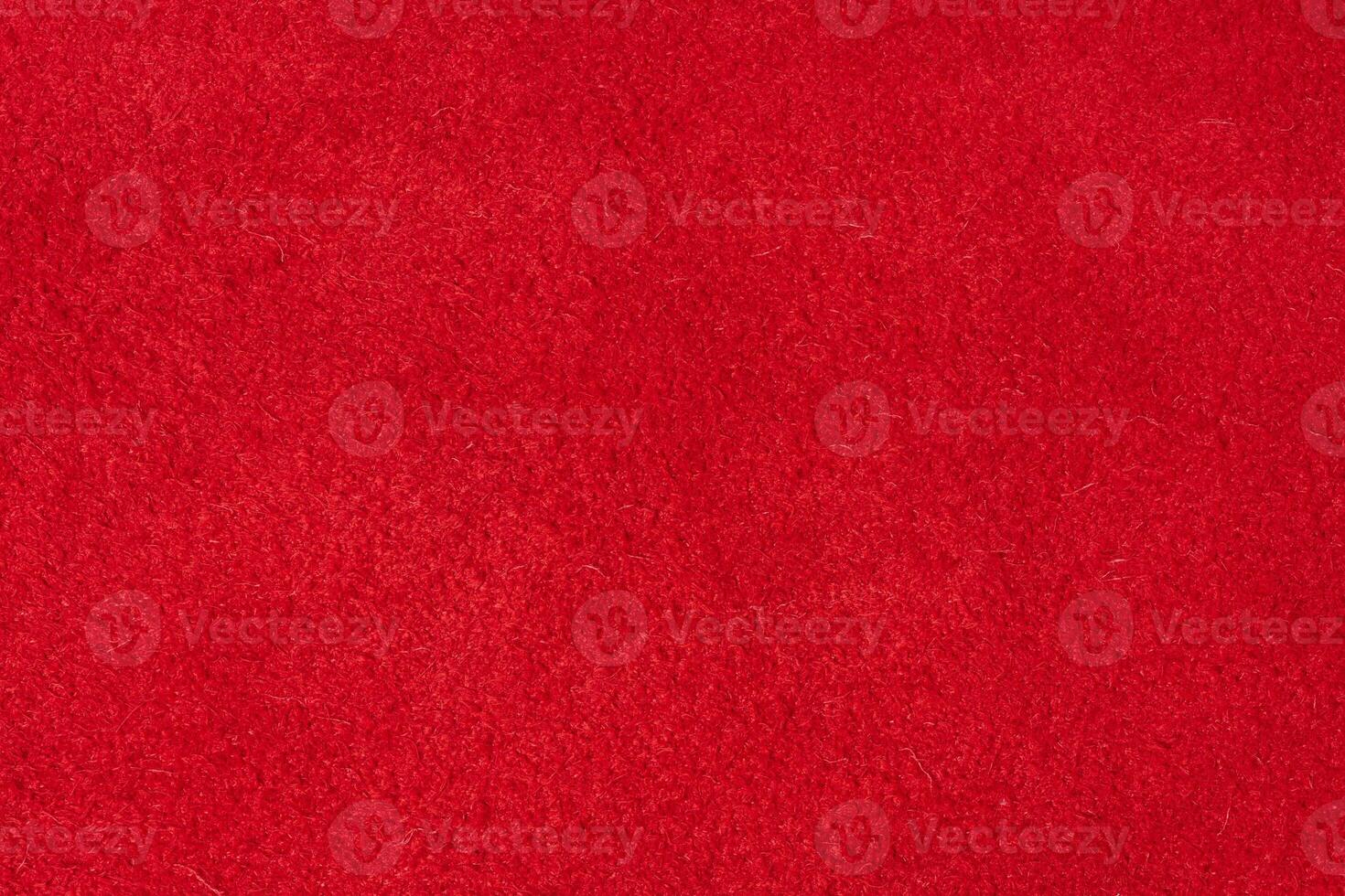 Close up of rich red suede showing the soft, shaggy surface texture with visible fibers photo