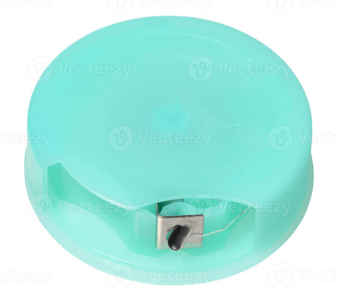 Round, mint green dental floss container with a metal cutter, designed for easy dispensing, isolated background photo