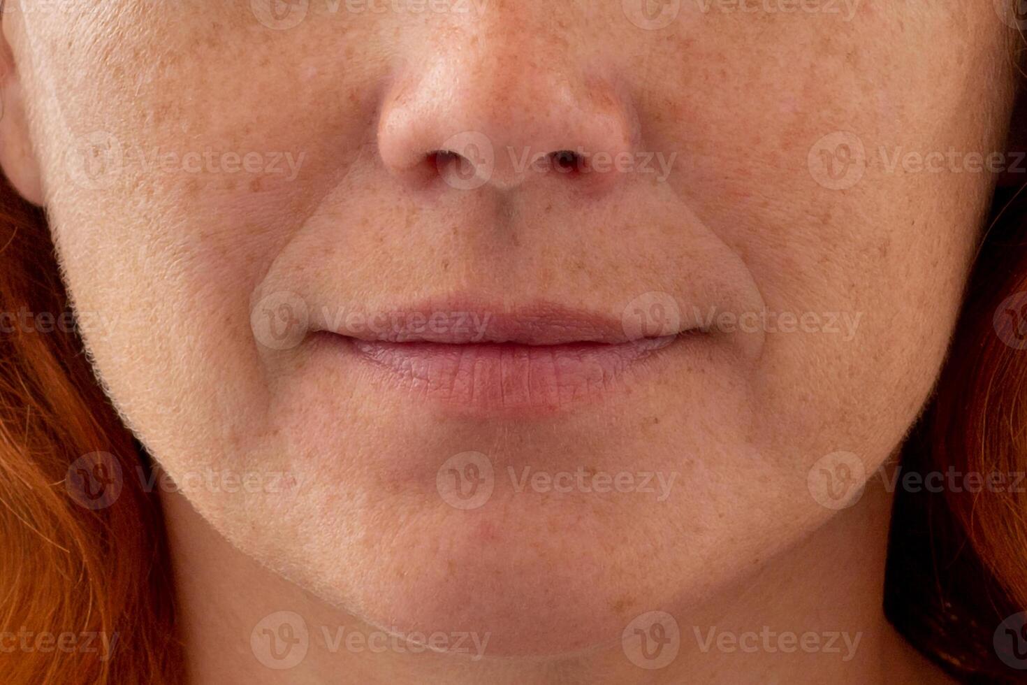 Close up of cropped middle aged caucasian woman face showing nasolabial folds and skin texture photo