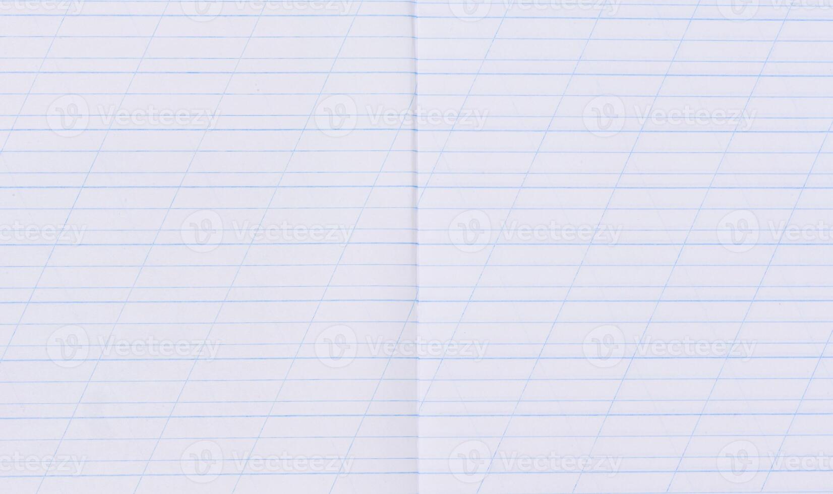 A close-up of a page from a school notebook with blue horizontal lines and diagonal guiding lines for handwriting practice photo