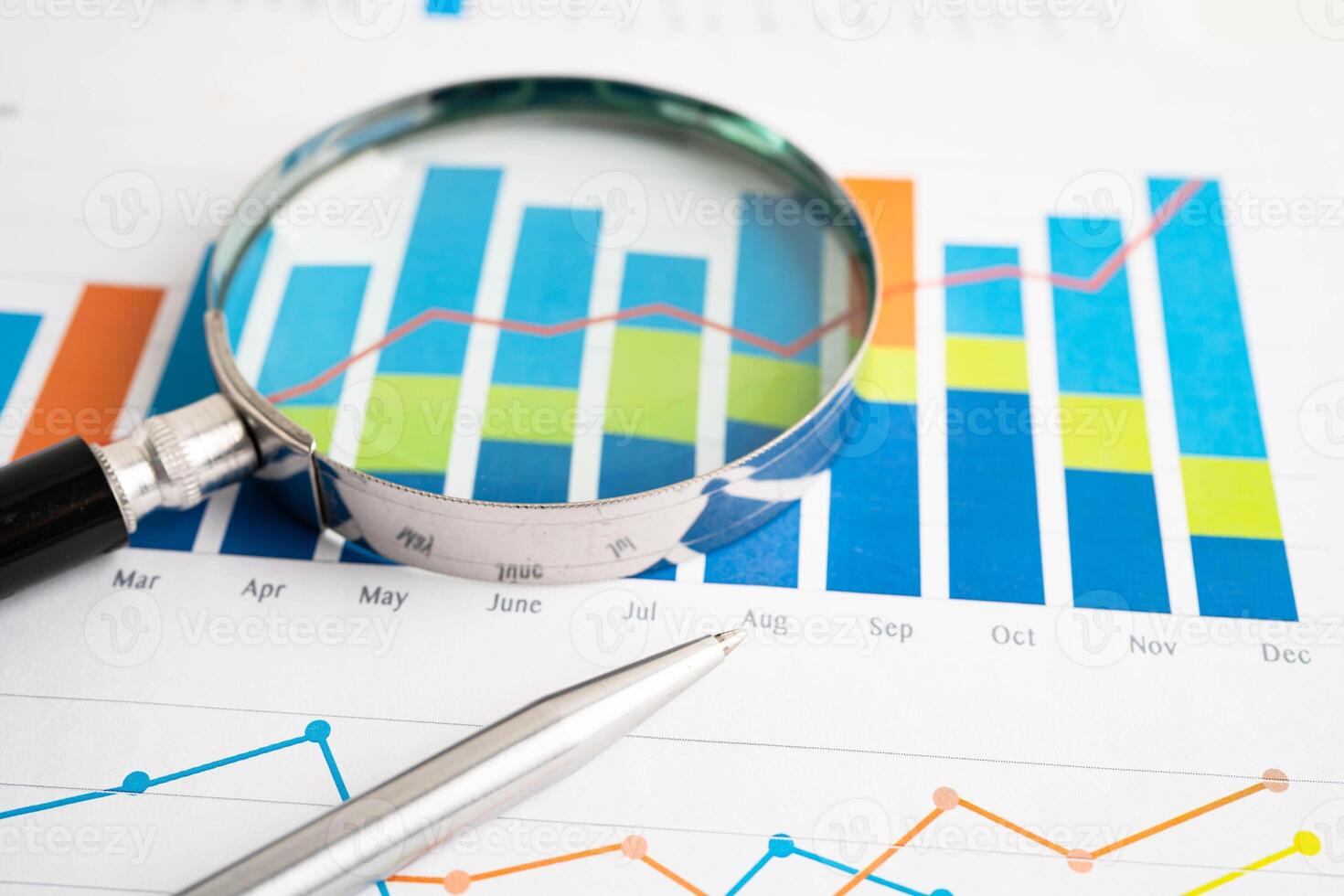 Magnifying glass on charts graphs paper. Financial development, Banking Account Statistic photo