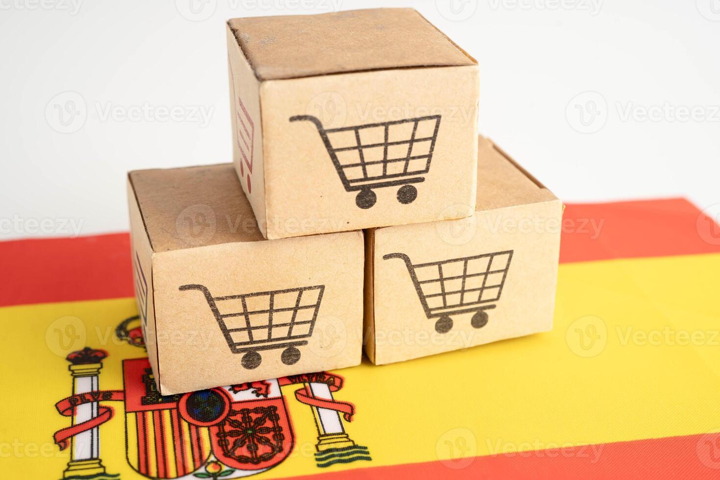 Online shopping Shopping cart box on Spain flag, import export, finance commerce. photo