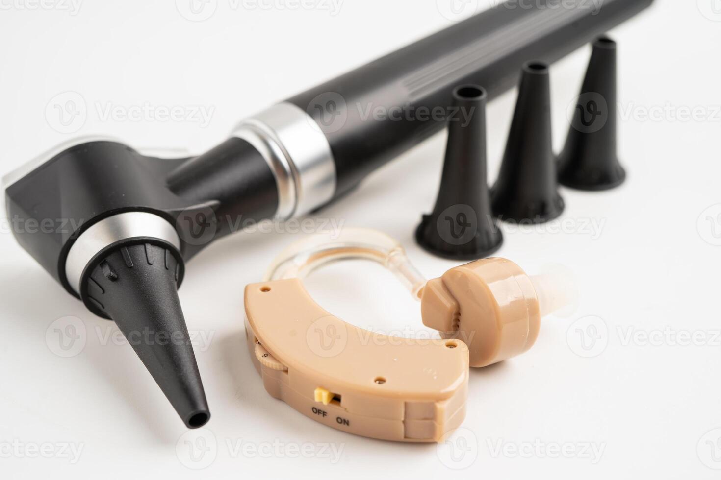 Otoscope isolated on white background for otolaryngologist or ENT physician doctor examining senior patient ear, hearing loss problem. photo