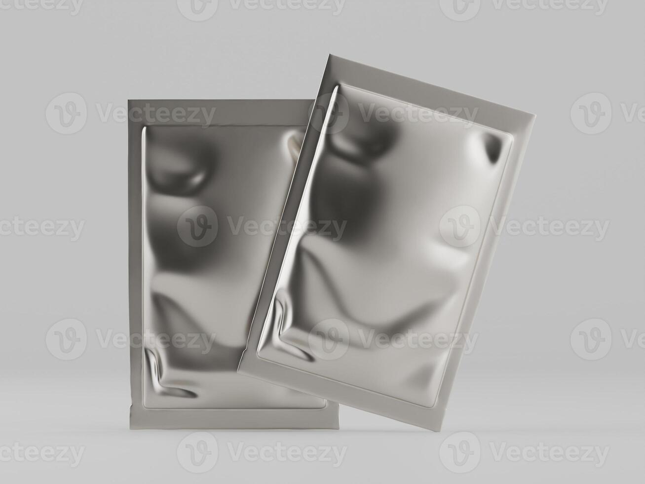 Two silver foil packages on a white surface photo