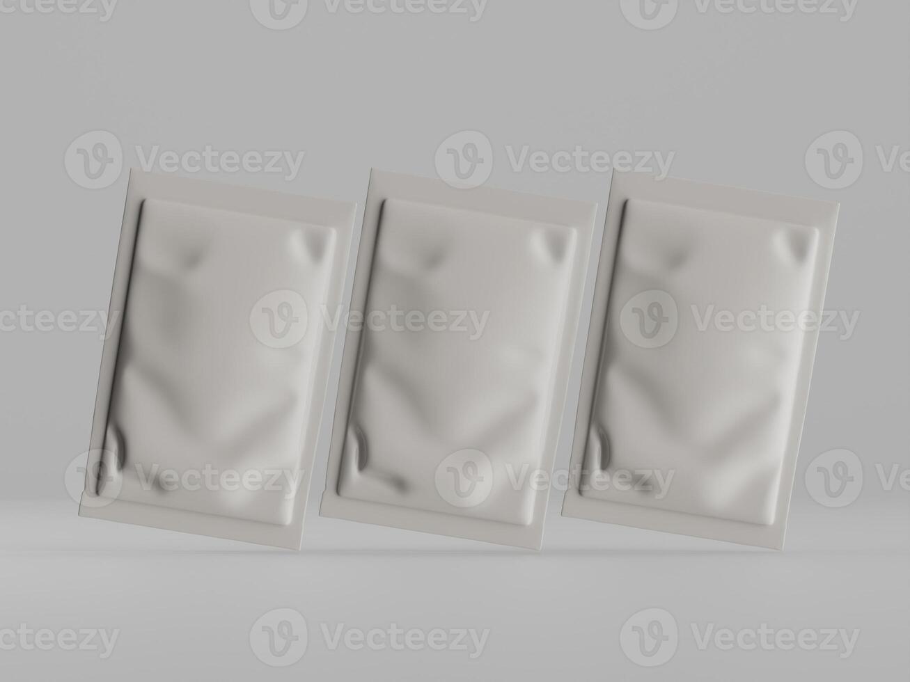 Three white packets of pills on a gray background photo