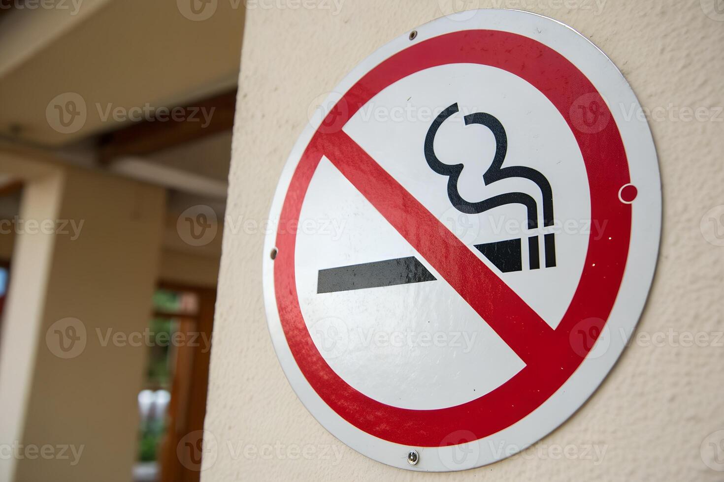 Stop smoking symbol. No cigarettes allowed, minimalist red prohibition sign on the wall photo