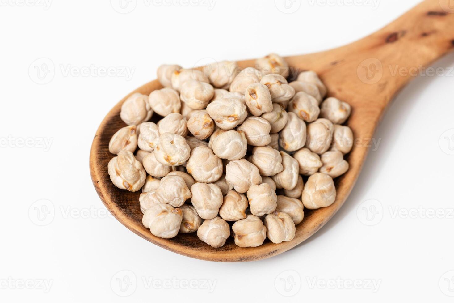 Close-up of a wooden spoon with raw chickpeas isolated on white background photo