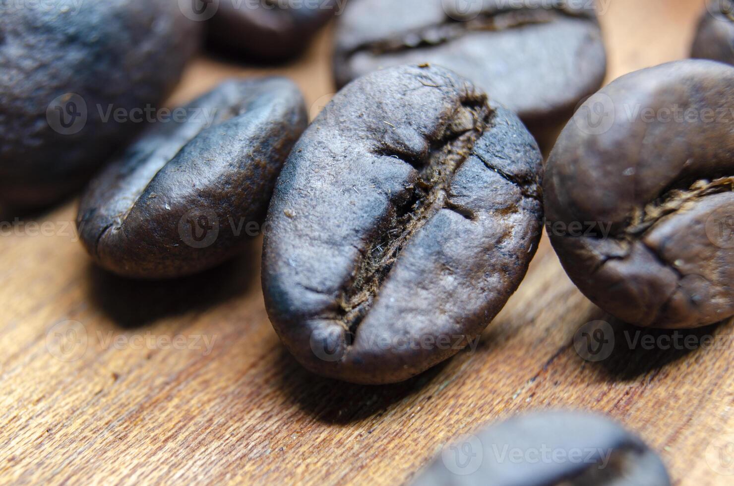 Close up view roasted coffee beans that highlights the texture and surface details of the coffee beans with customizable space for text. photo