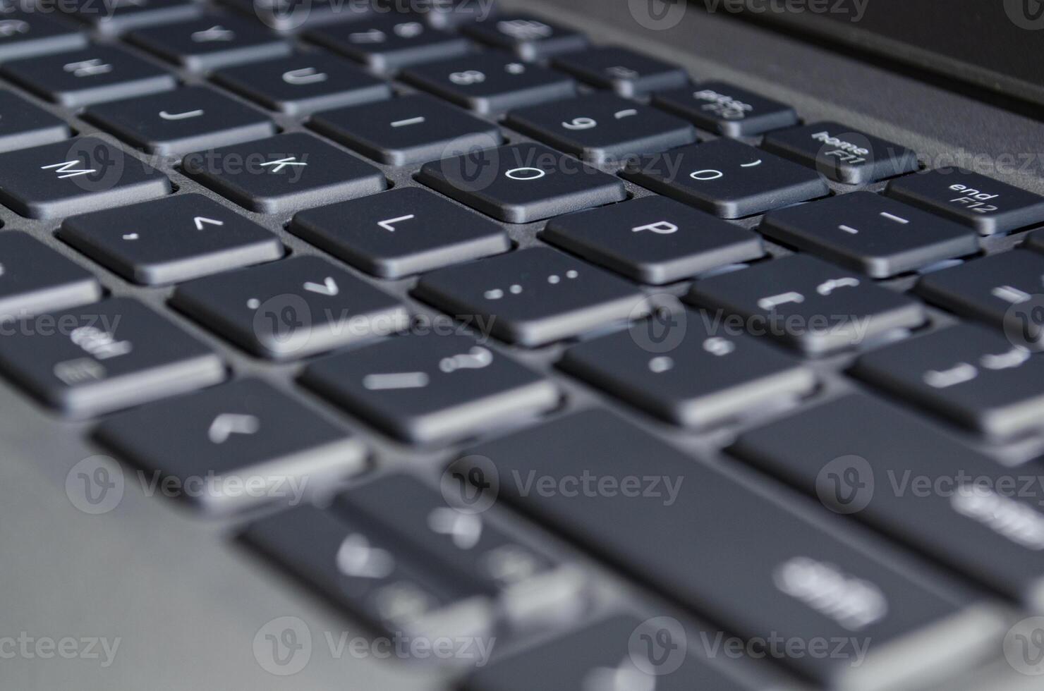 Laptop keyboard view symbolizing digital workspace and potential surface for cybersecurity risks. photo