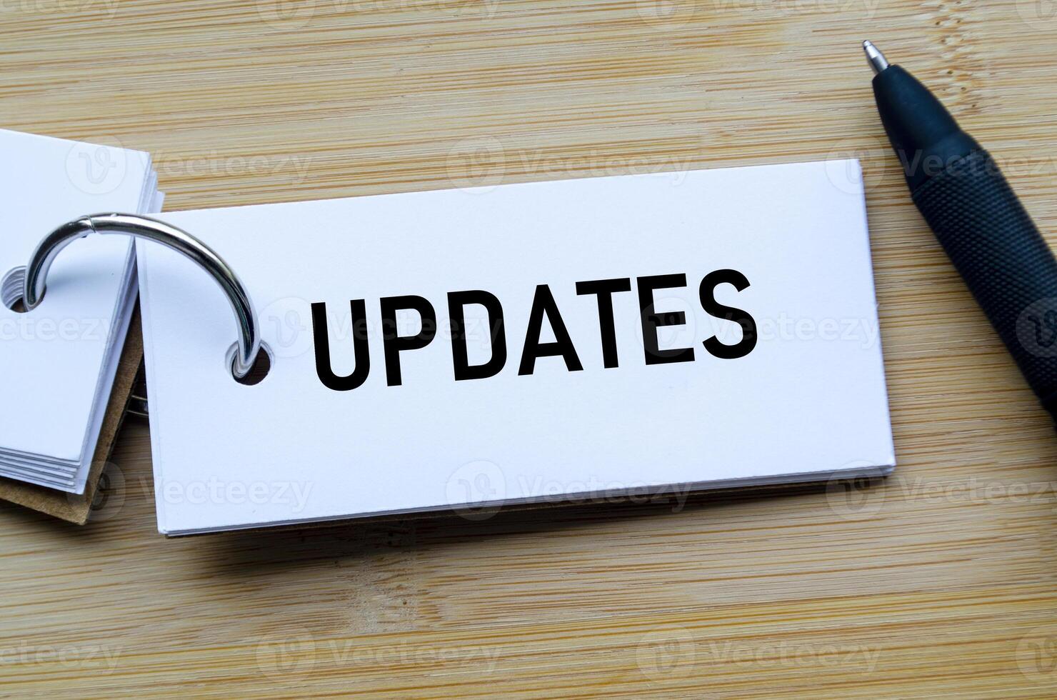 Updates text on notepad emphasizing timely communication and progress tracking in business photo