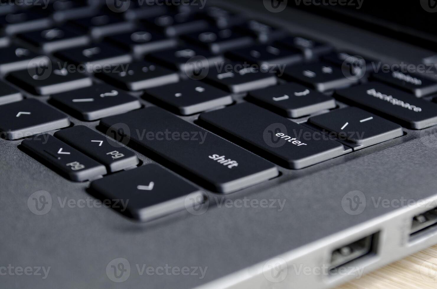 Close up of laptop keyboard and ports demonstrating physical access points for cyber threats. photo
