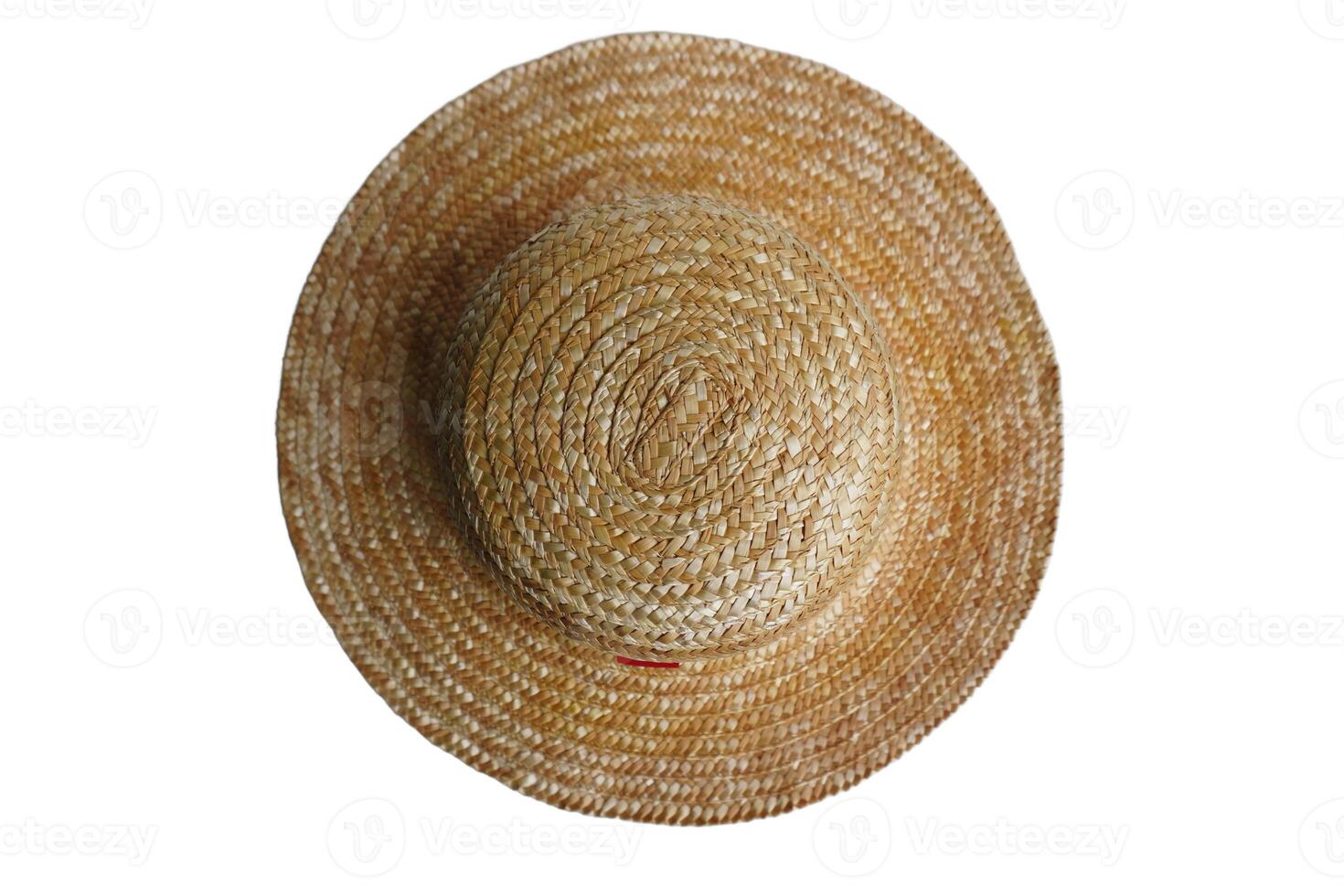 A straw hat, with a red ribbon tied around it. The hat is sitting on a white background photo