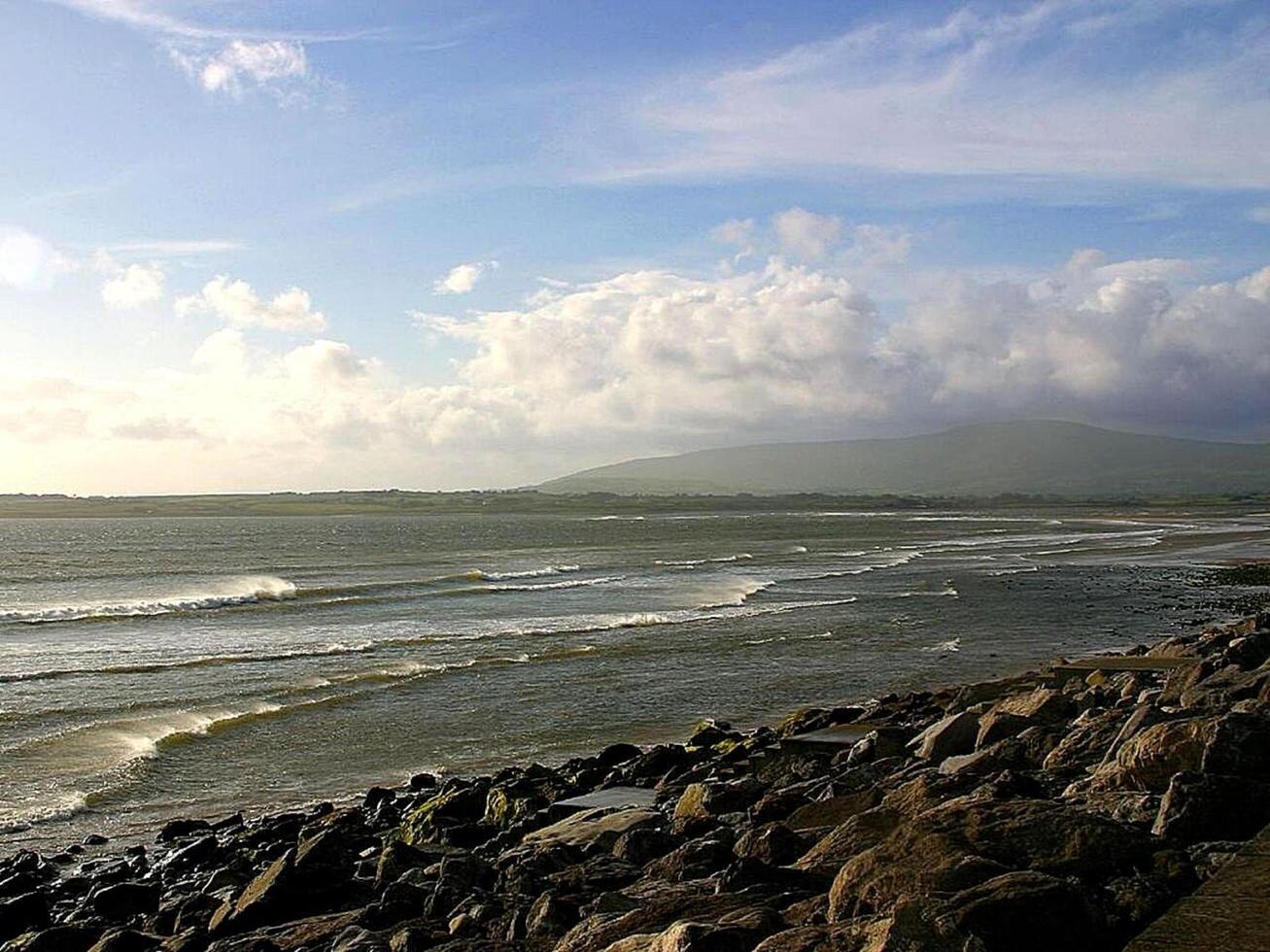 a view of the ocean from a rocky shore photo