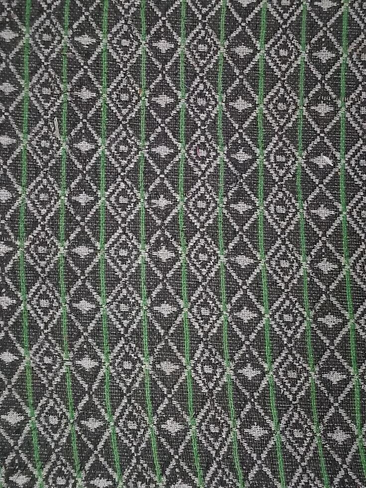 a black and green patterned fabric with a diamond pattern photo