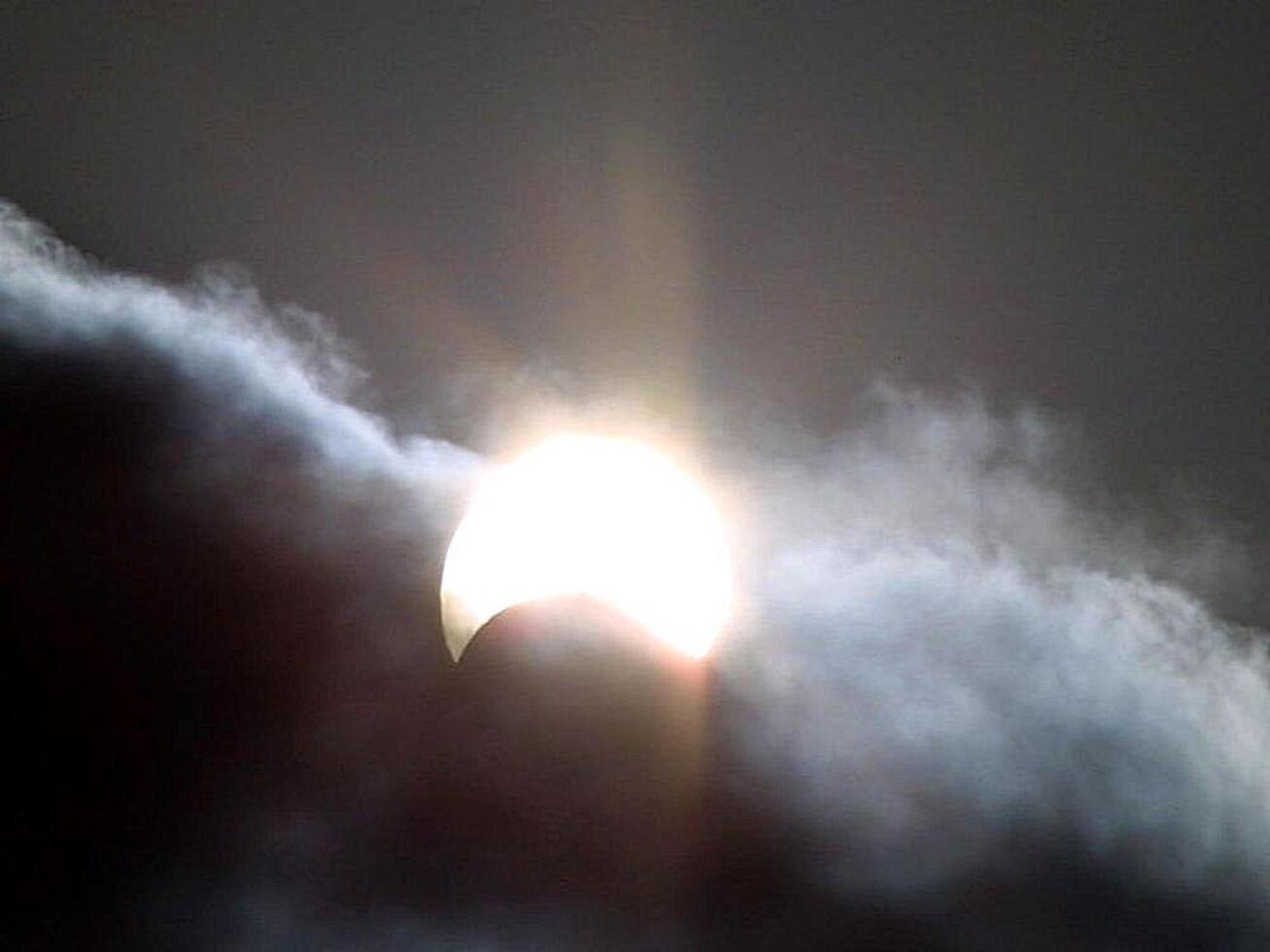 the sun is seen through the clouds during an eclipse photo