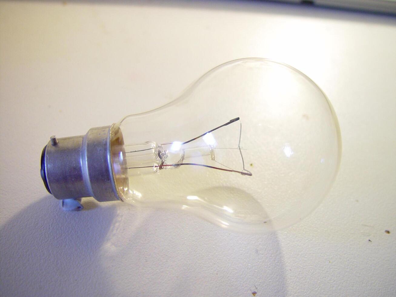a light bulb on a table with wires photo