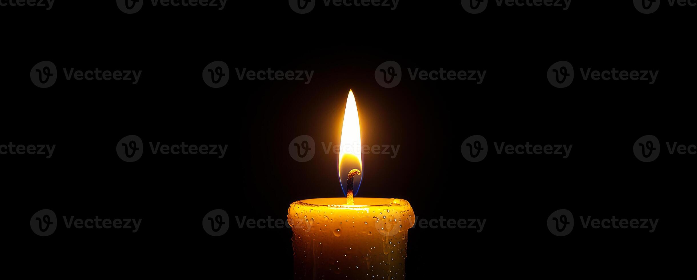 Warm glow of a candle flame in darkness. A single candle illuminated in a dim environment, with a vibrant flame flickering gently as droplets adorn its surface. photo