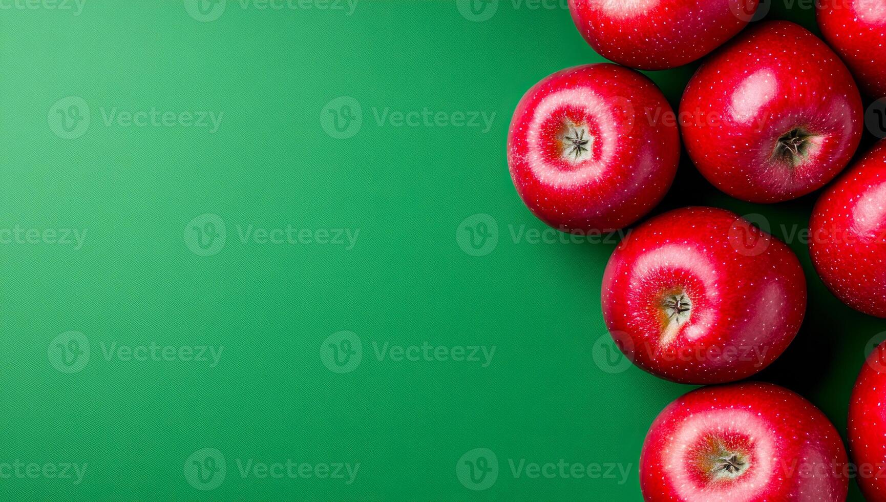 Fresh red apples on green background. Red apples arranged on a vibrant green surface create an inviting and fresh display ideal for healthy eating themes. photo