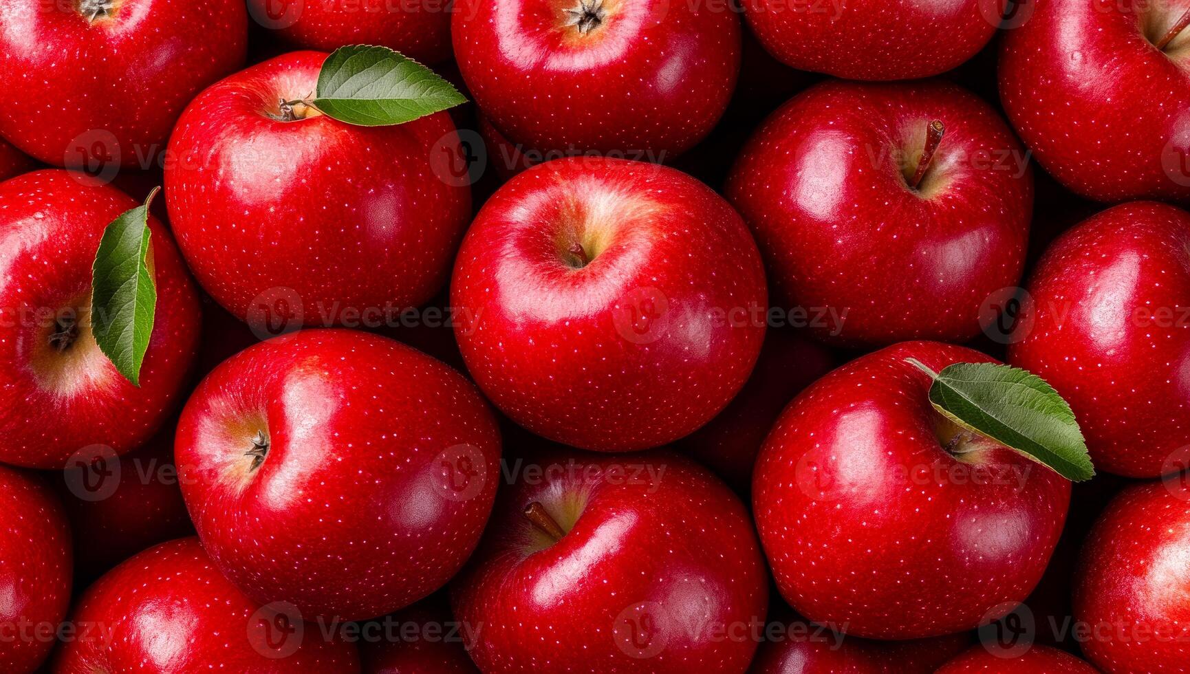 Fresh red apples in a vibrant display. Bright red apples with green leaves are arranged closely, showcasing their natural shine and freshness. photo