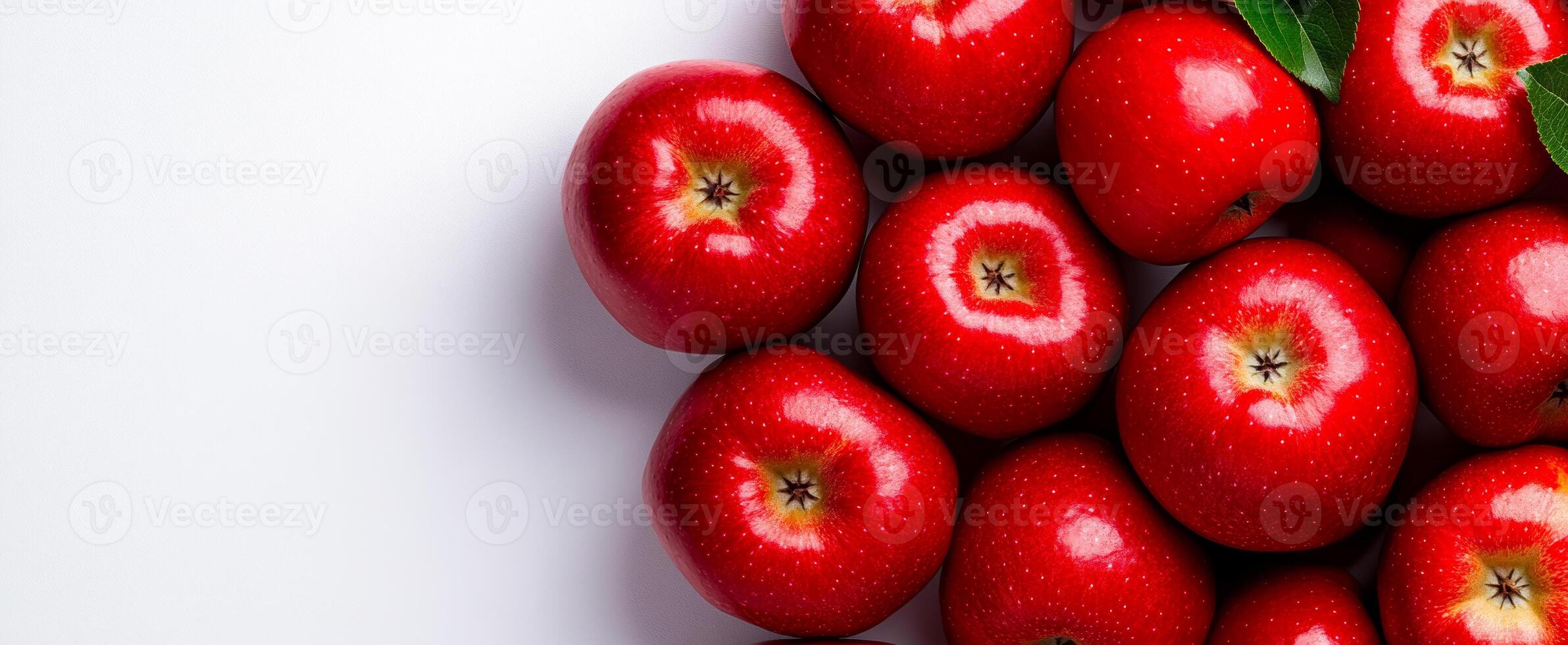 Red apples on a white surface. Bright red apples on a clean white background highlight their glossy skin and vibrant color. photo