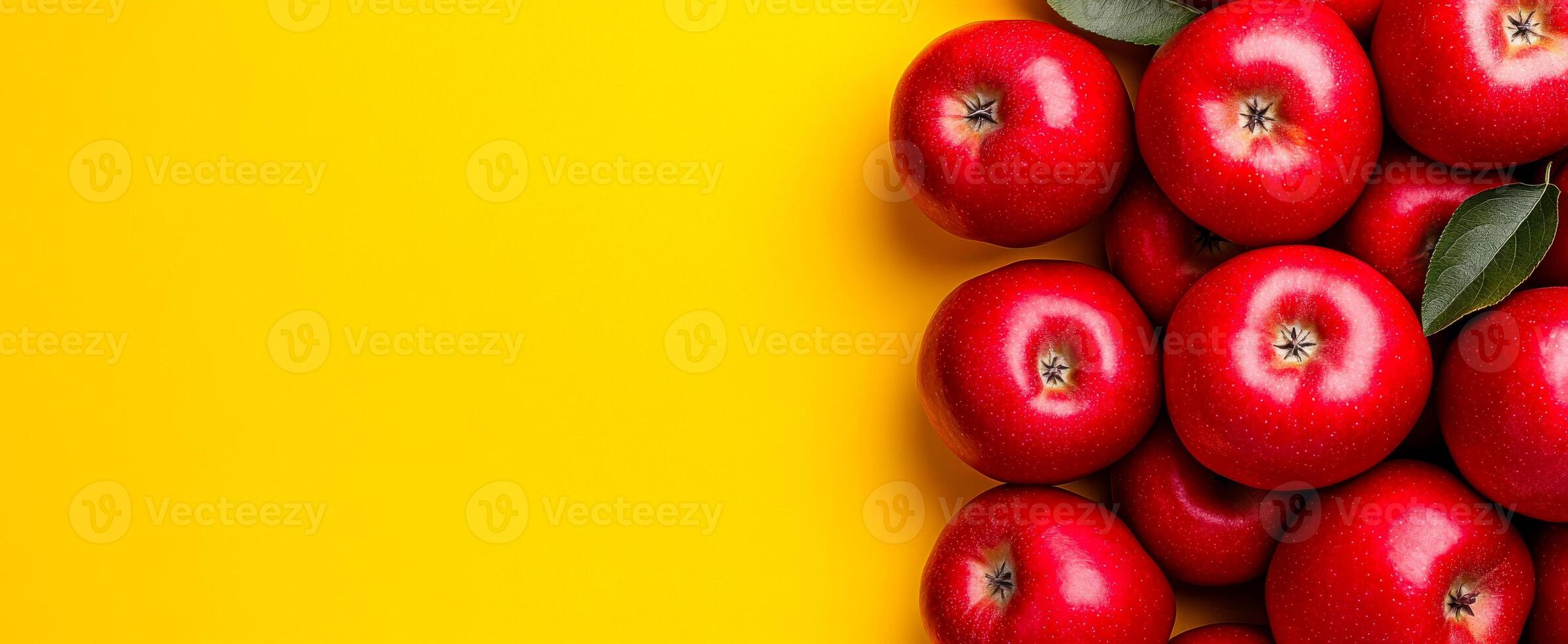 Red apples on yellow. Bright red apples arranged neatly against a bold yellow backdrop create a cheerful and inviting display. photo