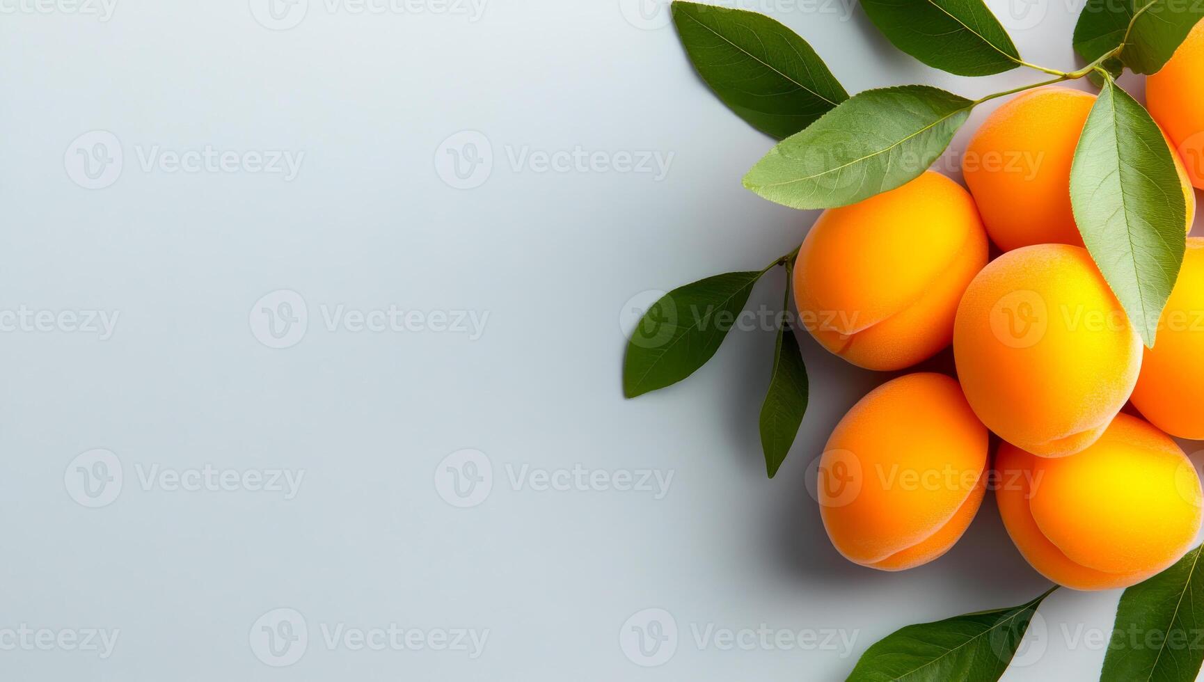Apricots with green leaves arranged. A group of vibrant apricots surrounded by green leaves sits on a light gray surface, showcasing their natural beauty. photo