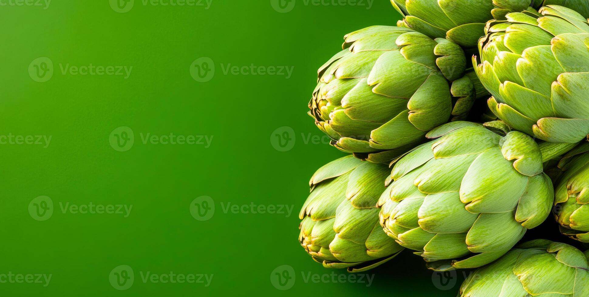 Fresh artichokes on green background. Fresh artichokes arranged beautifully against a vibrant green background, showcasing their natural texture and color. photo