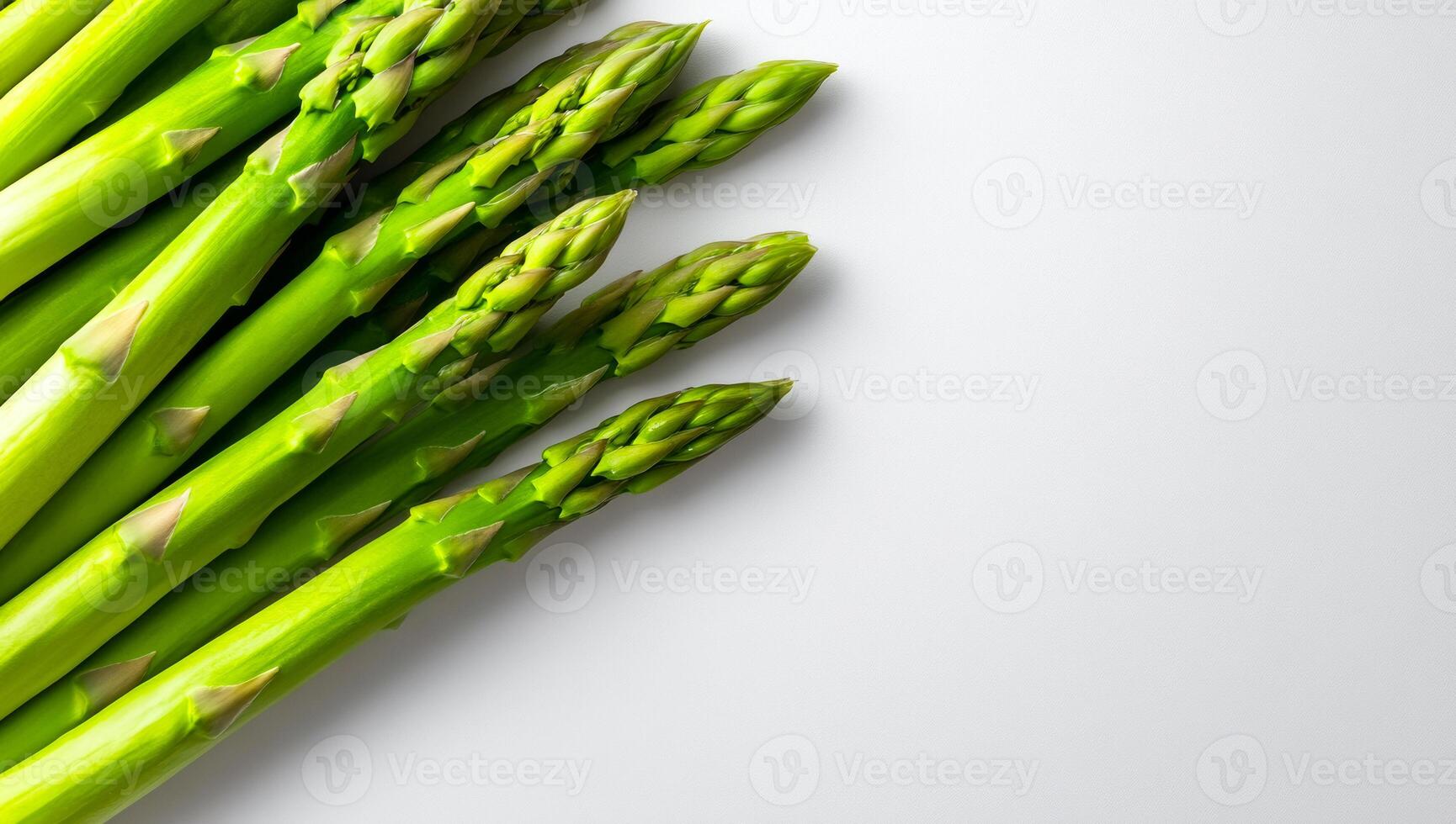Green asparagus on white. Fresh green asparagus spears arranged on a clean white background showcase their crisp texture. photo