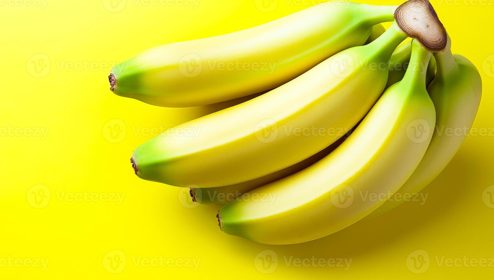 Vivid yellow with fresh bananas. A cluster of ripe bananas sits neatly against a bright yellow background, showcasing their smooth texture and color. photo