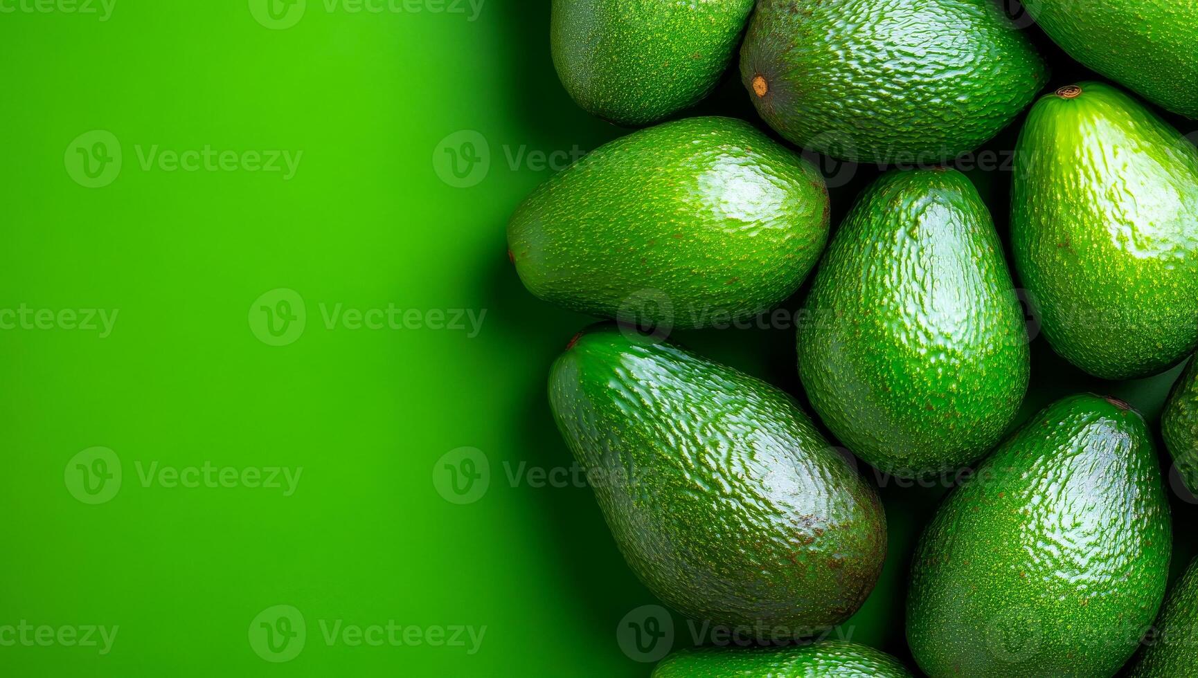 Ripe avocados ready to eat. A vibrant display of freshly harvested green avocados on a bright green surface, highlighting their smooth texture. photo
