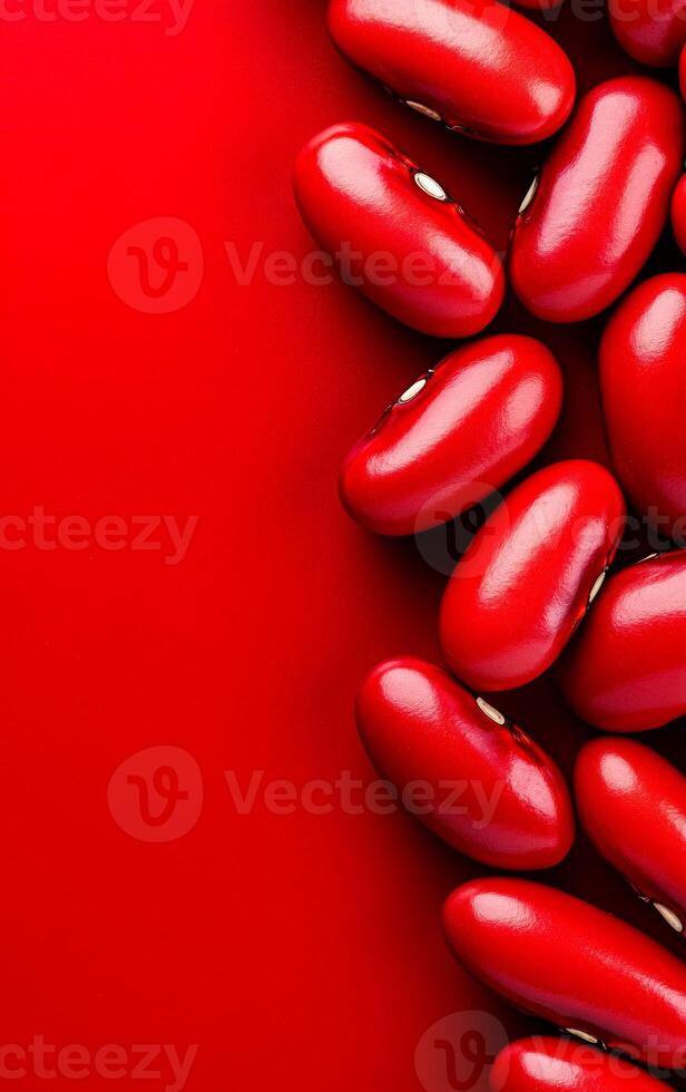 Red kidney beans on vibrant background. Red kidney beans arranged on a bright red background create a striking visual display of color and shape. photo