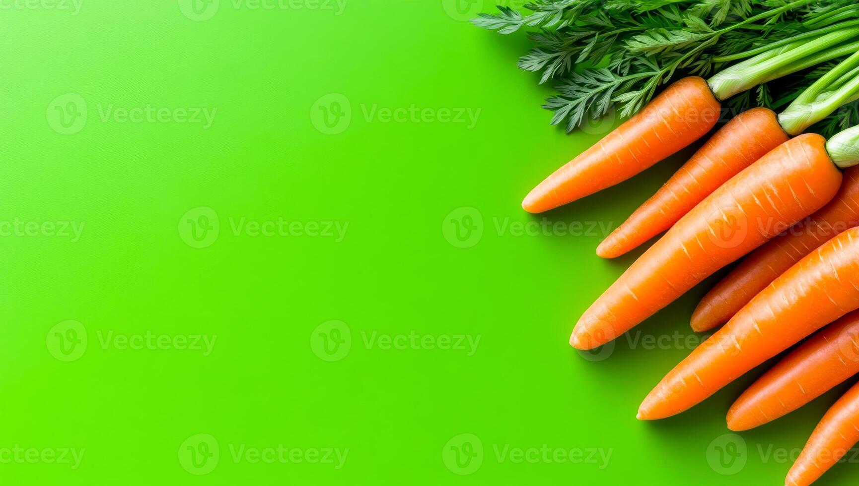 Fresh carrots on green. Bright and vibrant carrots with green tops are arranged on a vivid green surface, showcasing their freshness and color. photo