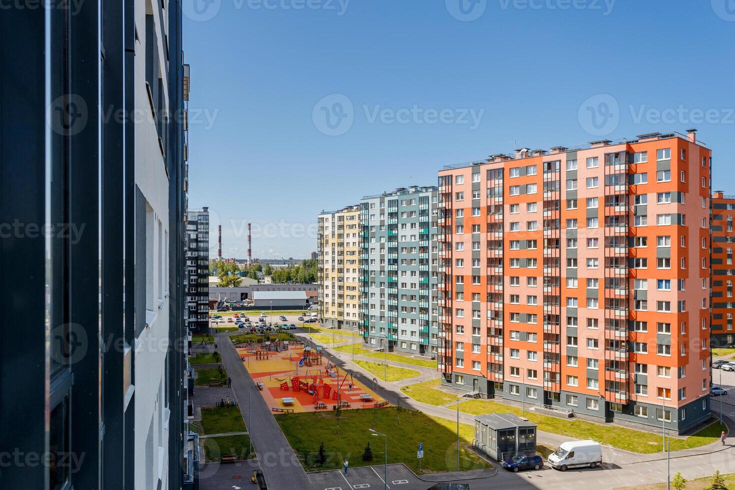 Colorful residential buildings and a landscaped area with a playground, top view photo